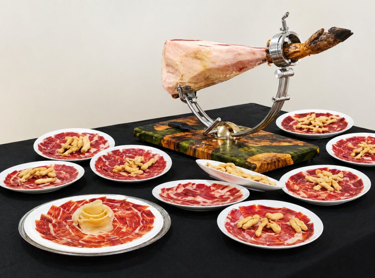 Elegant display of Spanish Serrano ham on plates with breadsticks, perfect for gourmet dining.